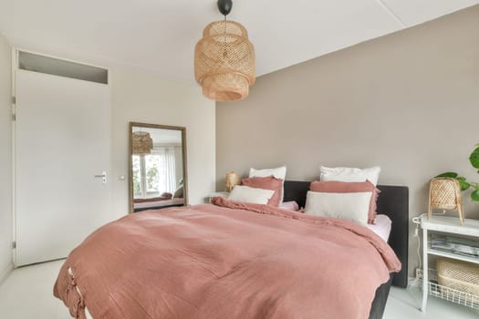 A stylish bedroom featuring modern decor, warm colors, and natural elements, creating a cozy and inviting atmosphere for relaxation or rest.