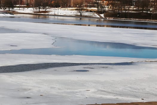 Small frozen river landscape in spring time before icedrift.