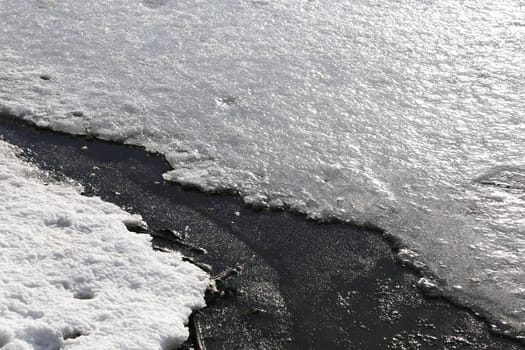 The process of ice melting before a flood. The surface of the river is covered with ice and snow.