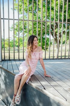 Woman in summer light dress in park on walk