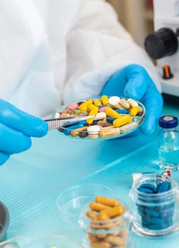 examine drugs in the laboratory. Selective focus. pills.