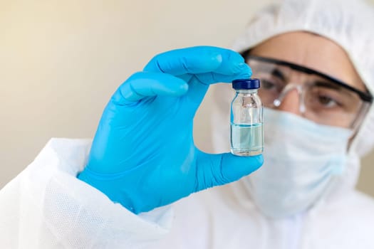 Medicine in a bottle in the hands of a doctor. Selective focus. vaccine