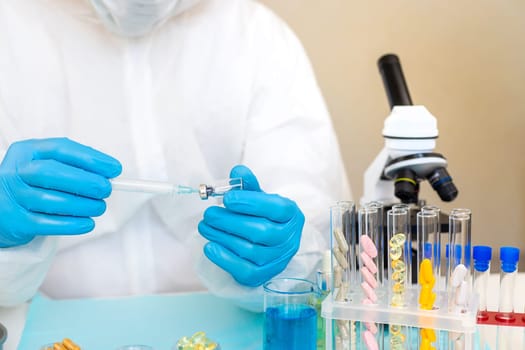 Medicine in a bottle in the hands of a doctor. Selective focus. vaccine