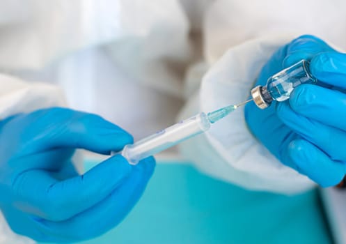 Medicine in a bottle in the hands of a doctor. Selective focus. vaccine