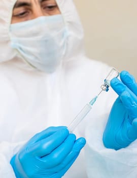 Medicine in a bottle in the hands of a doctor. Selective focus. vaccine