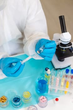 Medicine in a bottle in the hands of a doctor. Selective focus. vaccine