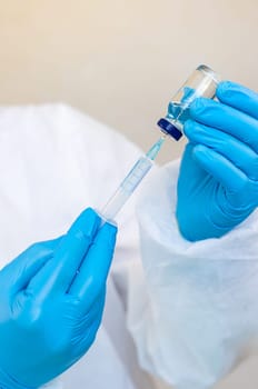 Medicine in a bottle in the hands of a doctor. Selective focus. vaccine