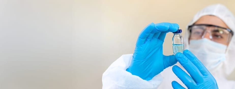 Medicine in a bottle in the hands of a doctor. Selective focus. vaccine