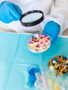 examine drugs in the laboratory. Selective focus. pills.