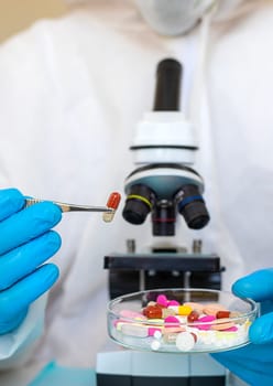 examine drugs in the laboratory. Selective focus. pills.