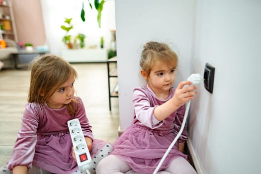 In a warm and inviting living room, two girls are engaged in a hands-on activity.