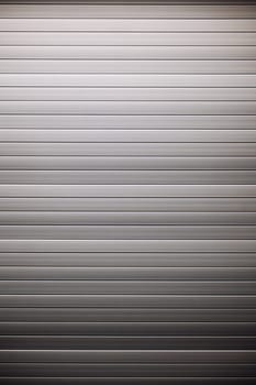 Metallic background formed by a corrugated iron sheet with horizontal stripes and a gradient from light gray to dark gray