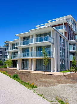Gravel pathway along the new residential buildings on blue sky background