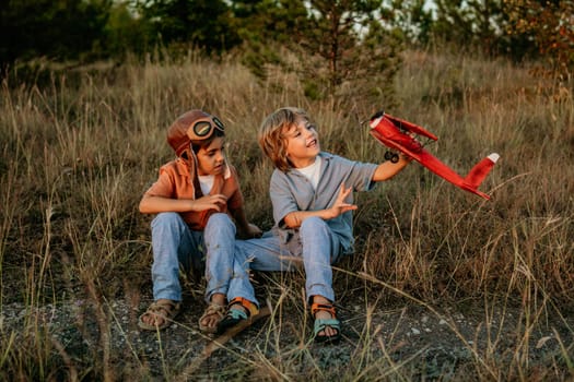 Smiling curious 5 years old preschool children boys playing, discussing aviation with craft wooden retro styled airplane toy, discovering future profession interests dreamer kids flying, traveling.