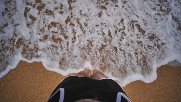 Turquoise waves splashing sandy shoreline near tourist's feet, experiencing summer leisure on crimean black sea coast