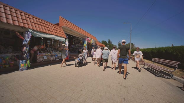 Tourists walking and shopping at a souvenir shop during summer vacation in Crimea, Russia