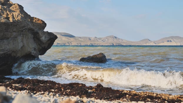 Seascape with waves crashing on the rocky beach of the Crimean peninsula