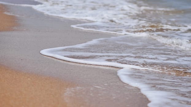 Gentle wave washing sandy beach of Crimea in summer, creating a peaceful and relaxing atmosphere