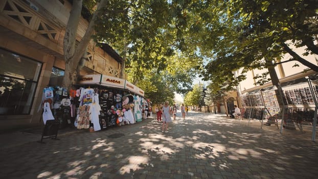 People walking and shopping on a street market in Crimea, Russia, during a sunny summer day