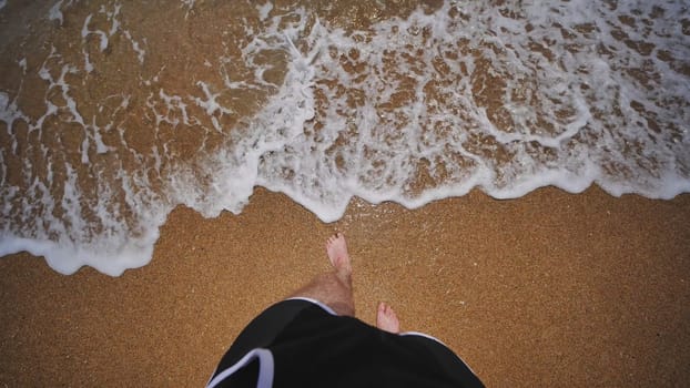 Point of view of a tourist entering the black sea from a sandy beach in crimea during a summer day