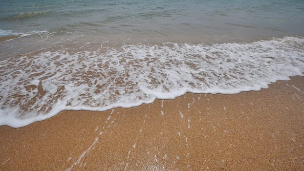 Gentle waves caressing golden sand, sunlight glistening across tranquil shoreline in scenic crimean coastal landscape