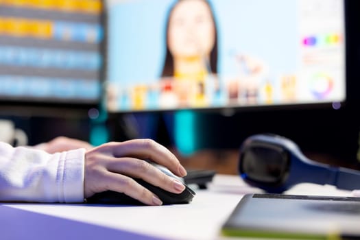 Photo editor color correcting photographs in creative studio using mouse and keyboard, close up shot. Photographer selecting best pictures for editorial content using retouching software