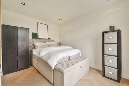 a bedroom with an upholing bed in the middle of the room and storage units on the right side