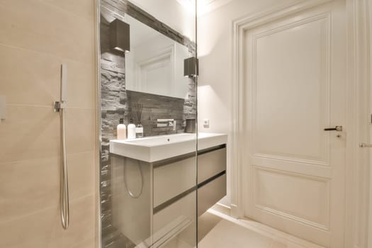a bathroom with a sink, mirror and toilet paper dispensed on the wall next to the door