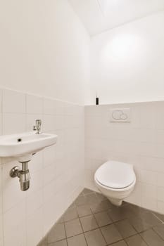 a bathroom with a sink and toilet paper dispensed on the wall next to it is a mirror