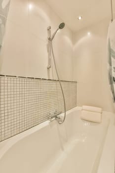 a man in the shower is on the wall above the bathtub and it's next to the toilet