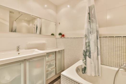 a bathroom with white tiles on the walls, and a large bathtub in the corner next to the sink