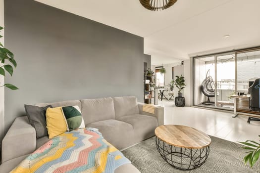 a living room with a couch, coffee table and television set in the corner on the wall is painted gray