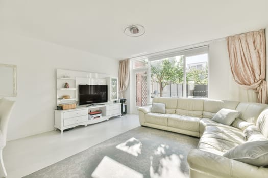 a living room with white furniture and pink drapes on the window is looking out onto an outdoor patio area