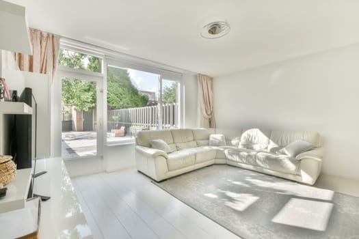 a living room with white couches and a television set in the center of the room is an outdoor patio