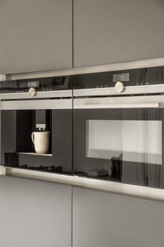 a modern kitchen with black and white appliances on the counter tops, including an oven hood in the middle part