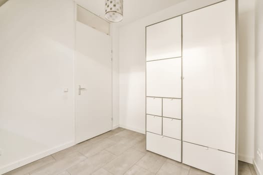 an empty room with white walls and wood flooring, there is a mirror on the wall in the corner
