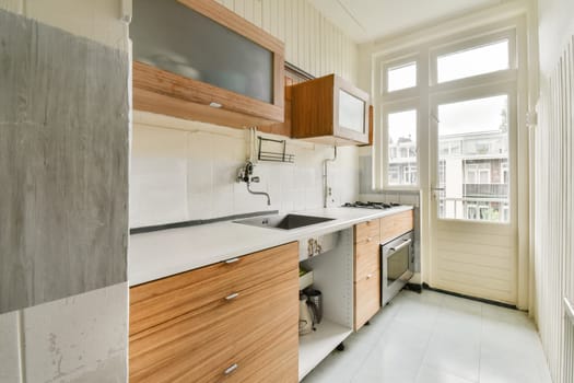 a kitchen with wooden cabinets and white counter tops on the floor in an empty room that has been used for many years