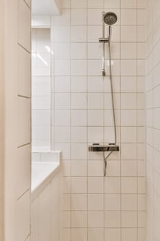 a shower with white tiles on the walls and floor in a small bathroom area next to a window that is open
