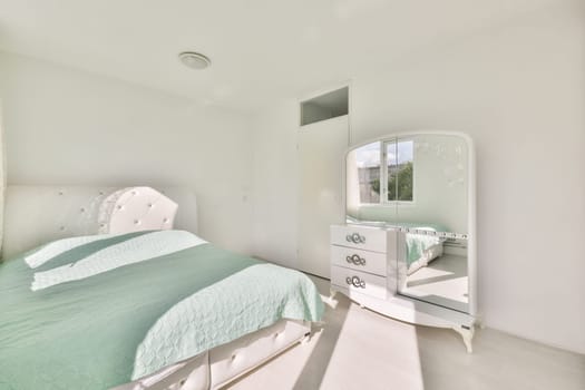 a bedroom with a bed, dresser and mirror on the wall in front of the room is very clean white