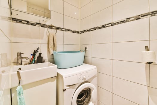 a laundry room with a washer and dryer on the wall next to the washing machine in the bathroom