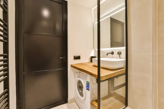 a laundry room with a washer and dryer in the corner next to the bathroom door, it's very clean