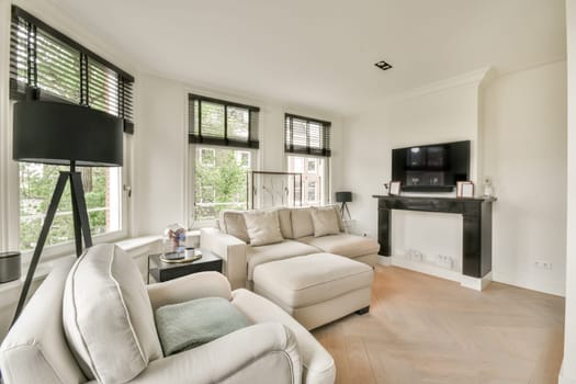 a living room with white couches and large windows that look out onto the trees in the distance is an outdoor fire place