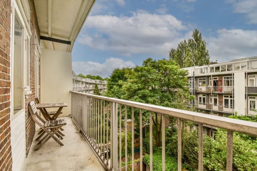 a balcony with chairs and trees in the background on a sunny day photo taken from an apartment balcony at sunset point apartments