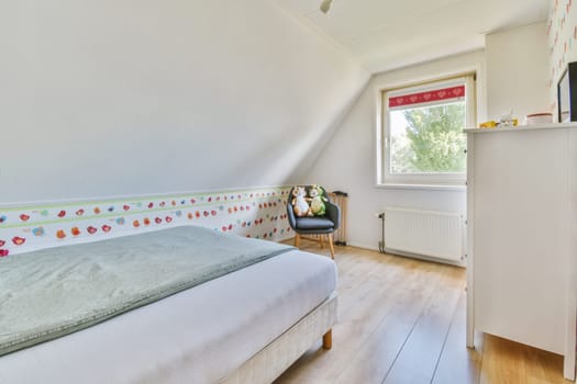a child's room with a bed, dresser and tv on the wall in the room is bright white