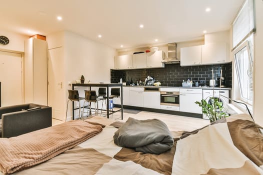a living room with an open kitchen and dining area on the other side of the room it is very clean