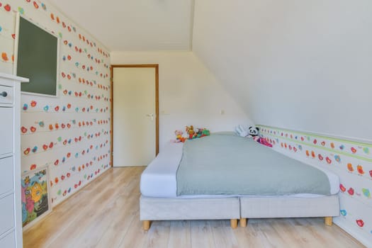 a child's bedroom with colorful wallpapers on the walls and white furniture in front of the bed