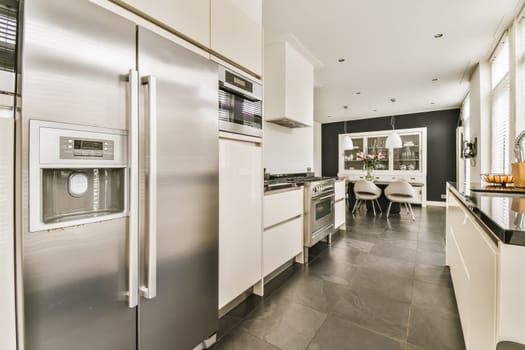 a modern kitchen with black and white tile flooring, stainless appliances and an island in the middle of the room