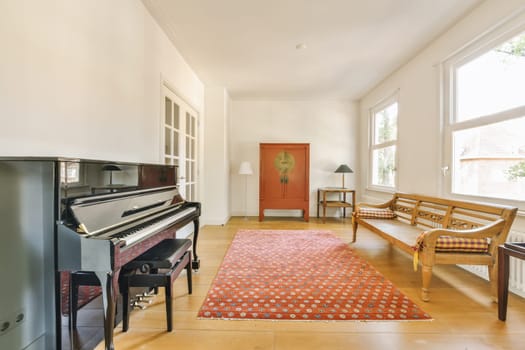 a living room with a piano in the middle and an old piano on the right hand side of the room