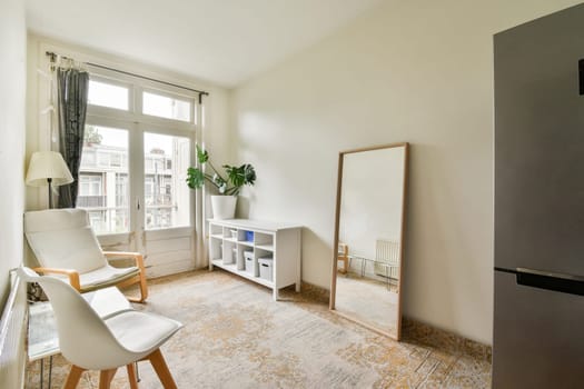 a living room with a chair, table and television on the wall in front of the tv is not visible
