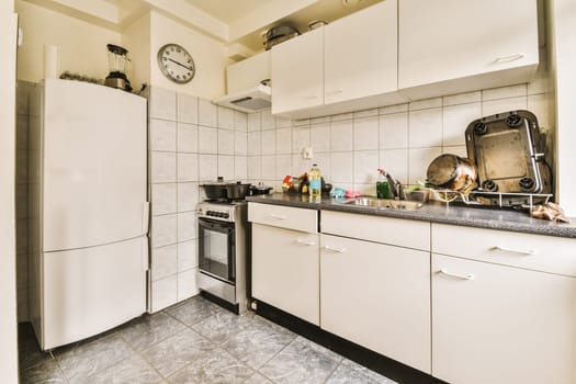 a kitchen with white cupboards and black counter tops on the counters in this photo is taken from the inside